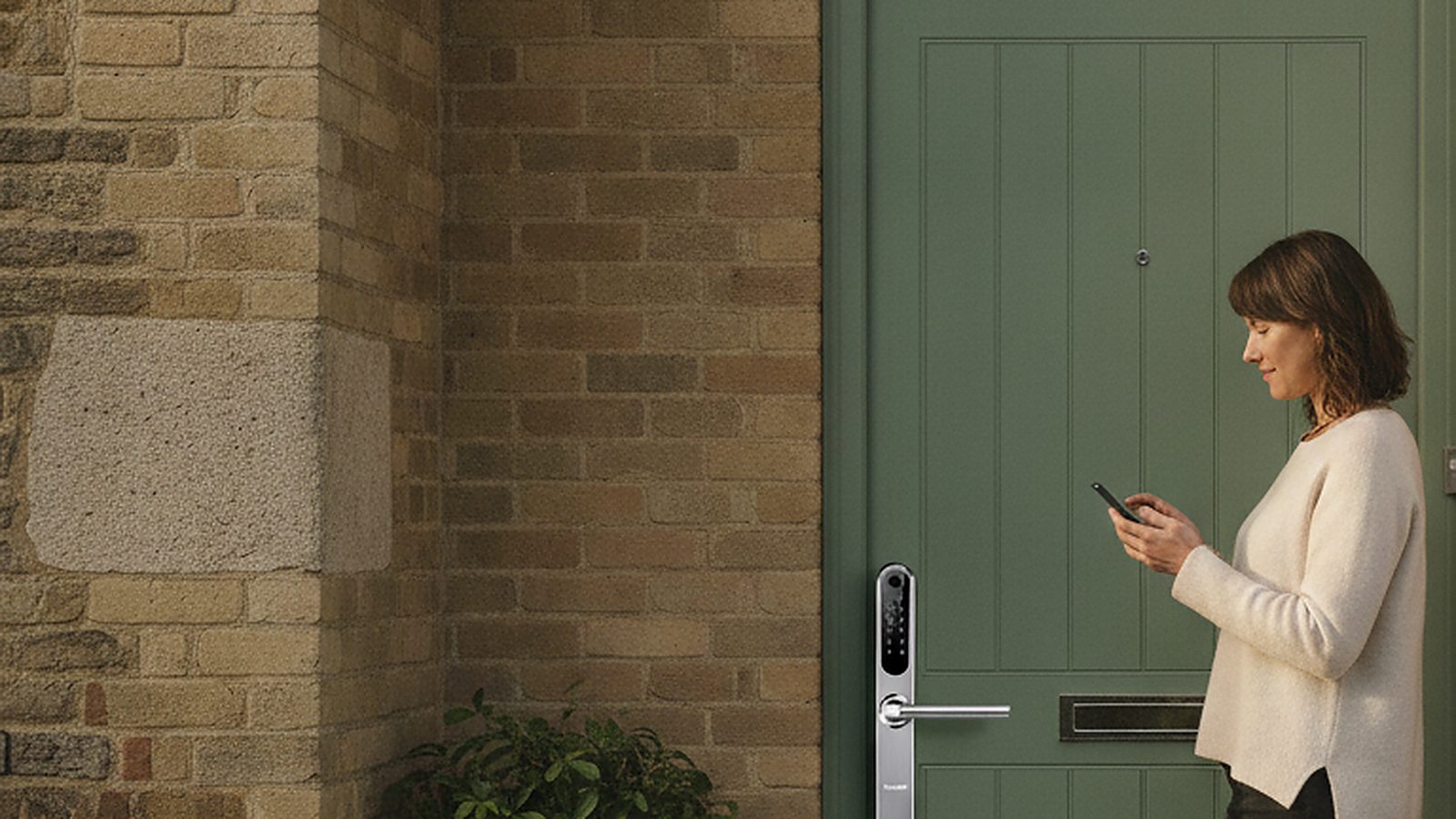 A homeowner unlocking their front door with the Simpled app